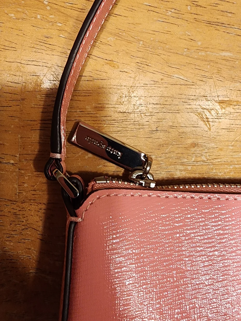Kate Spade New York Gemini Convertible Wristlet in a pink color